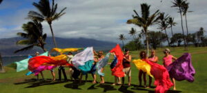 A group of people standing on top of a green field.