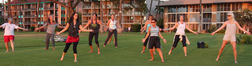 A group of women are playing frisbee in the grass.